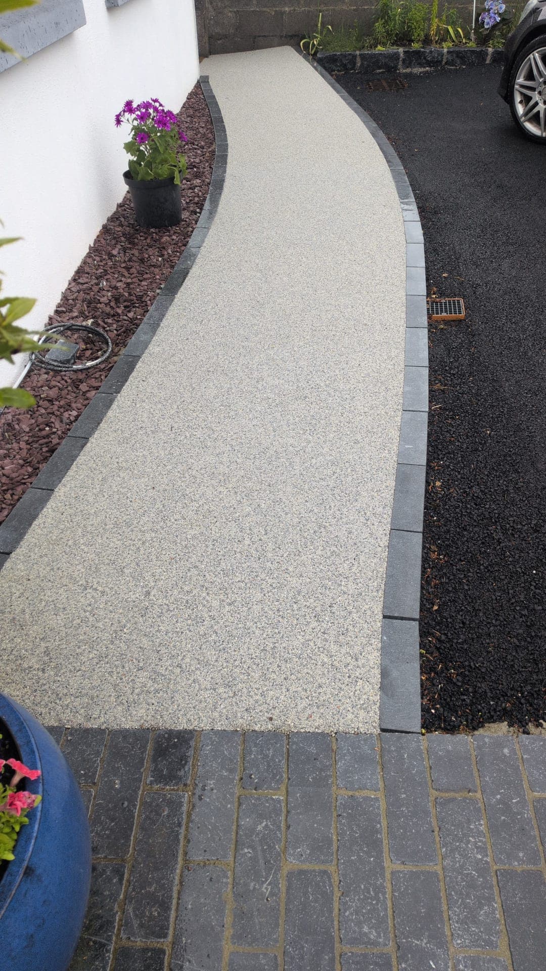 Garden Pathway with Cobblestone Border — A buff-finish path bordered in granite setts, leading out to the driveway.